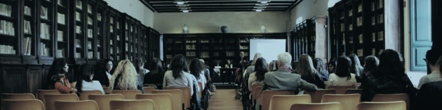 A conference presenter in front of their audience